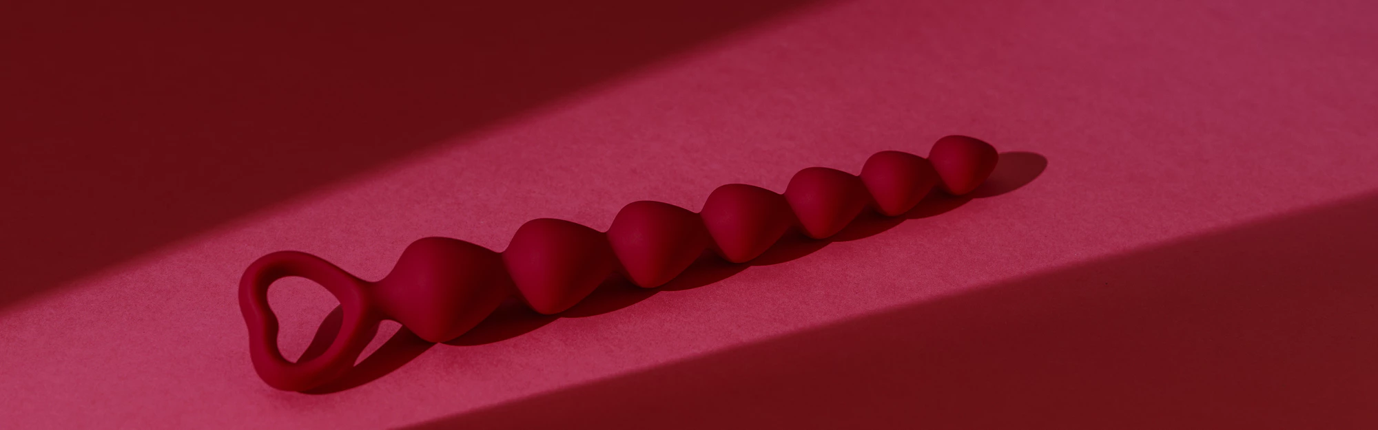 anal-plug-or-dildo-on-pink-background-with-shadows-2023-06-29-19-26-10-utc.webp